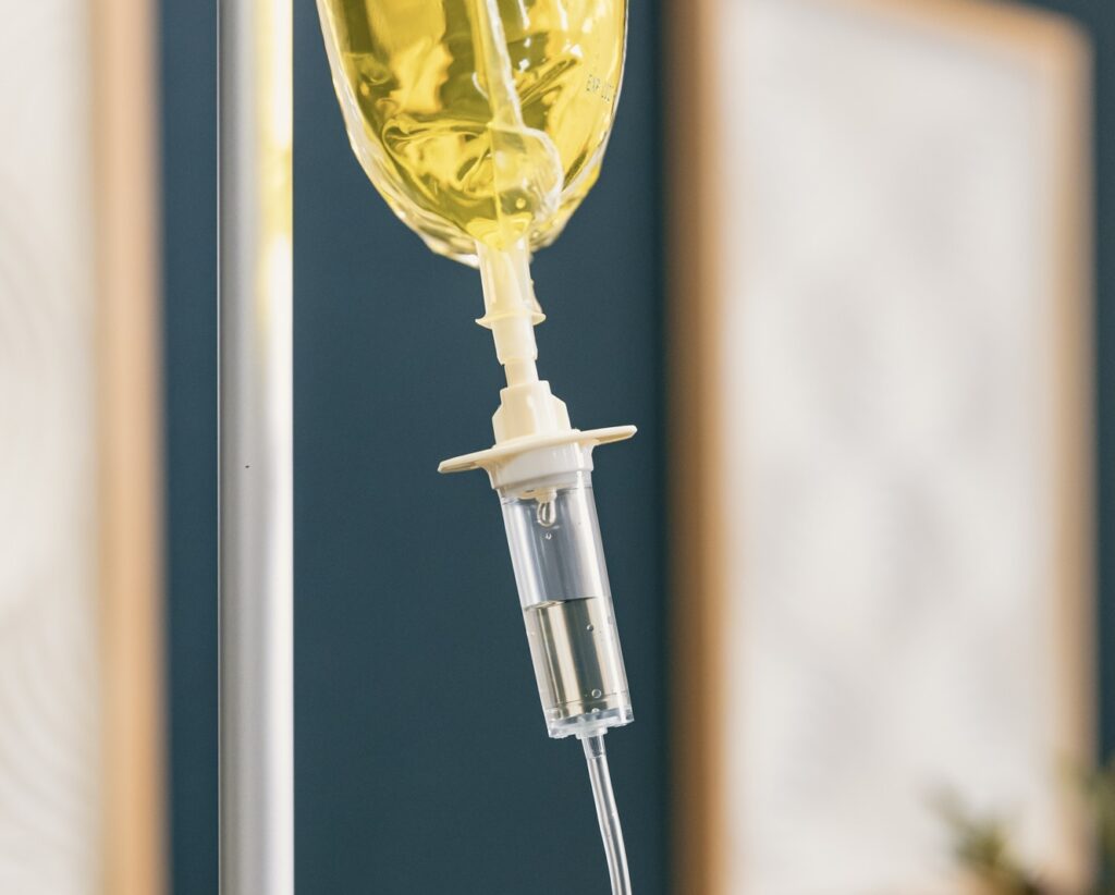 An IV bag with a custom drip formula sits hooked up to a tube, ready for IV infusion in Reno.